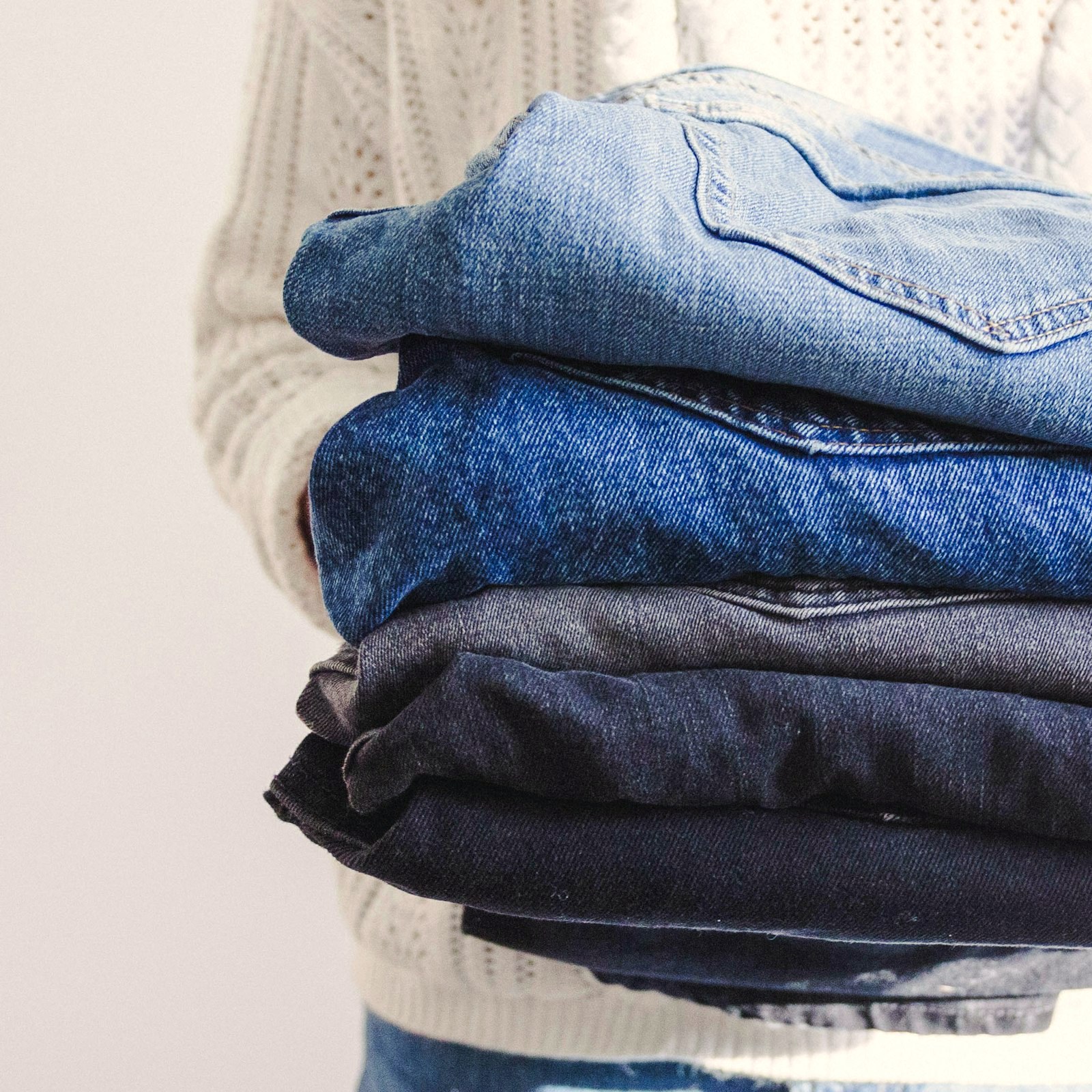 A stack of folded jeans in dark indigo