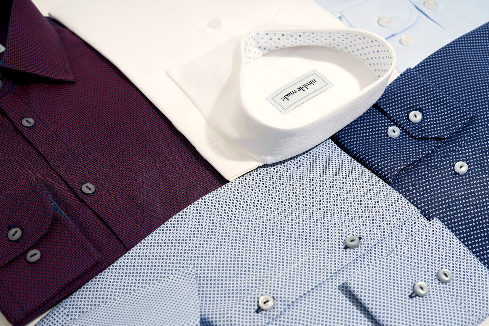 A stack of folded dress shirts