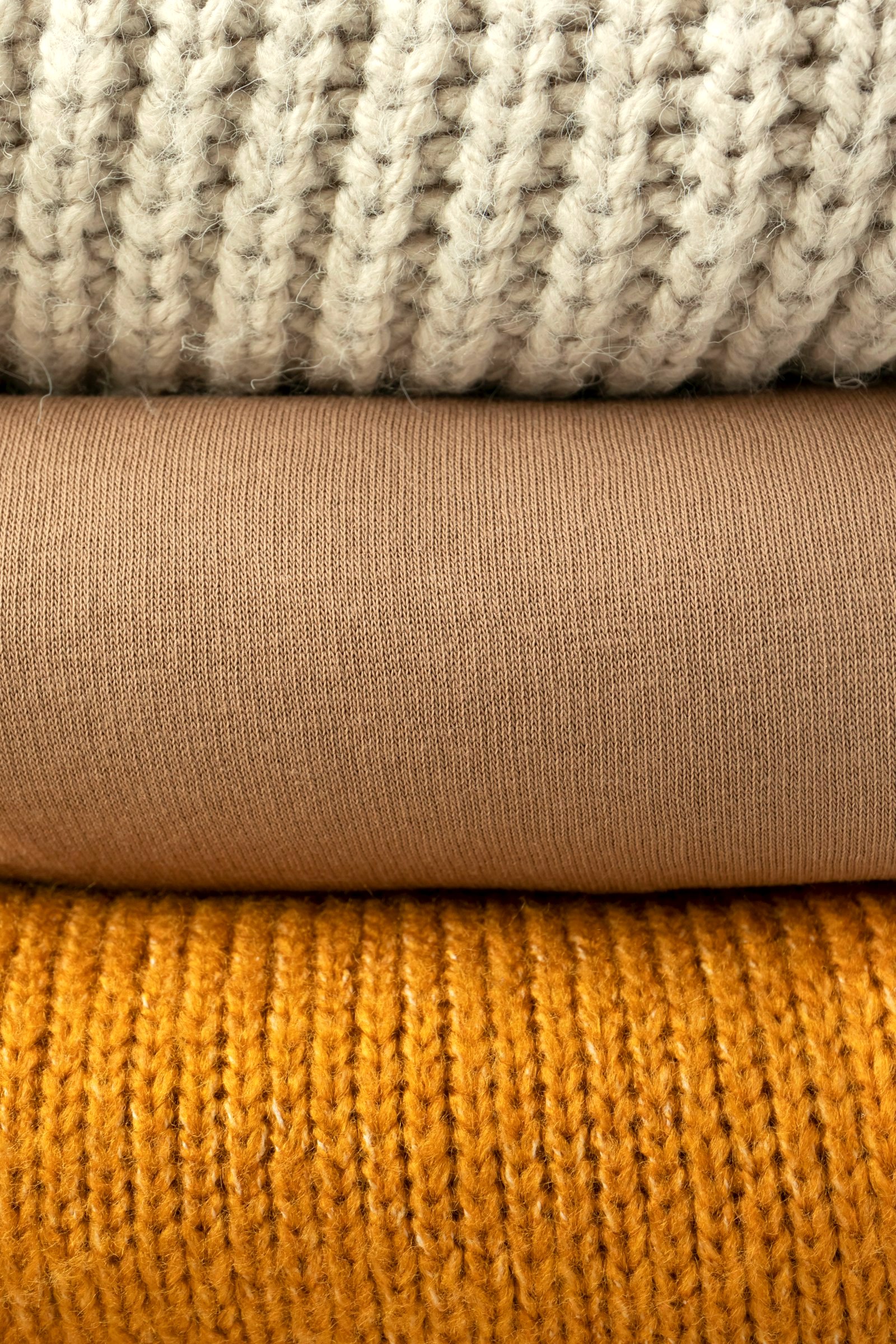 Close view of stacked knitted textures