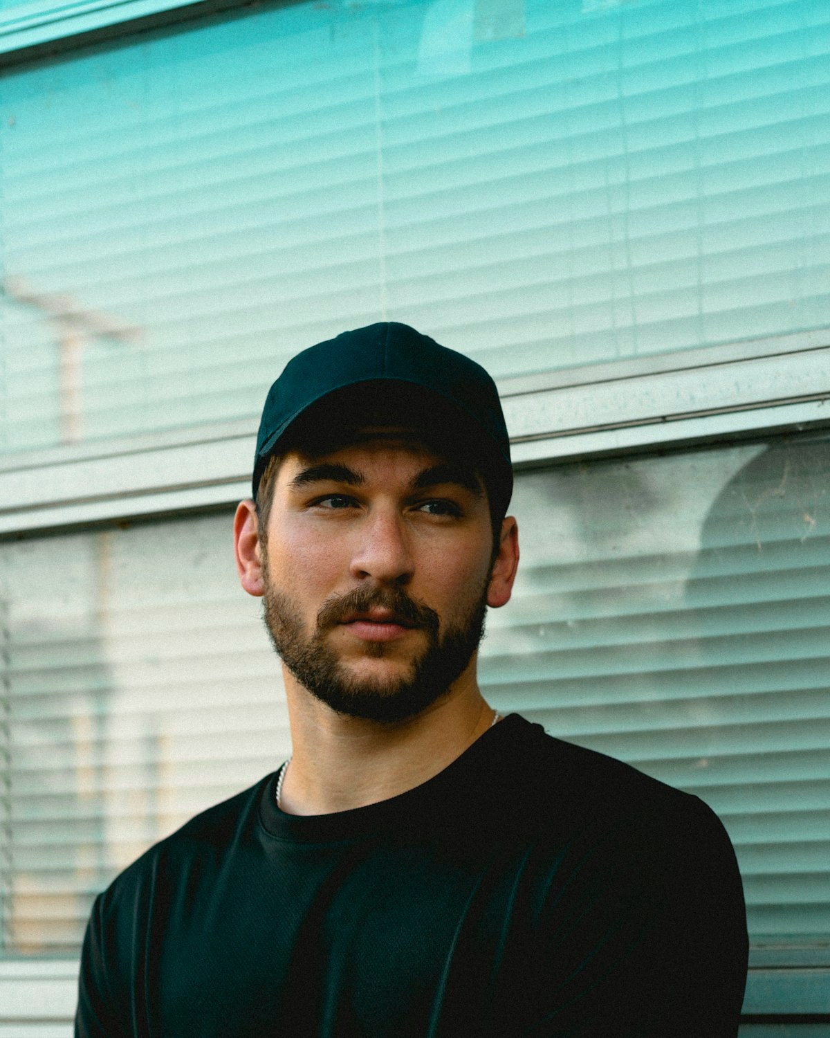 Young man in a black cap and black t-shirt, portrait