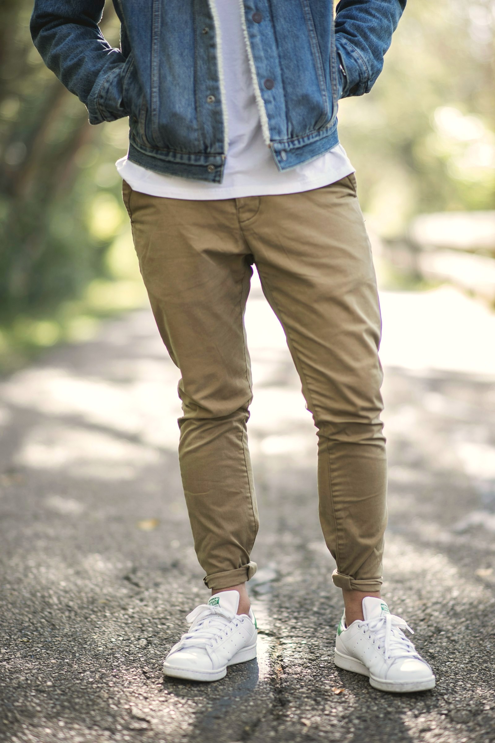 Man crossing a street in khaki chinos and a tucked shirt