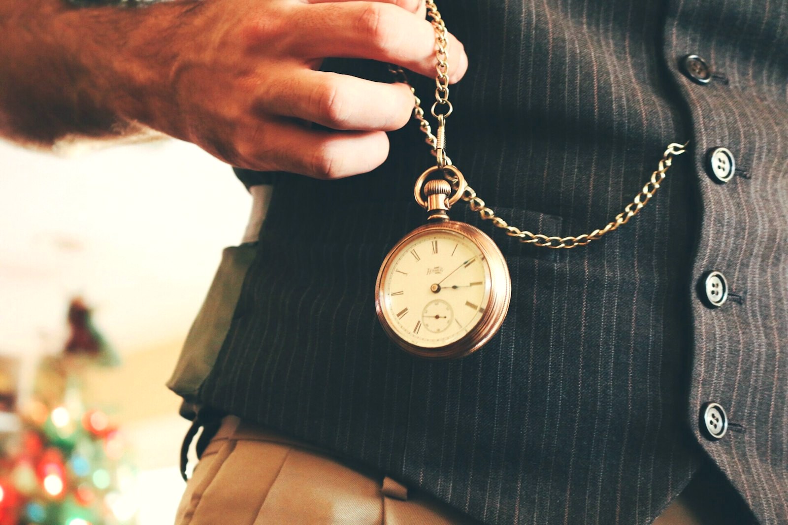 A pocket watch held in hand on its chain, heritage carried daily