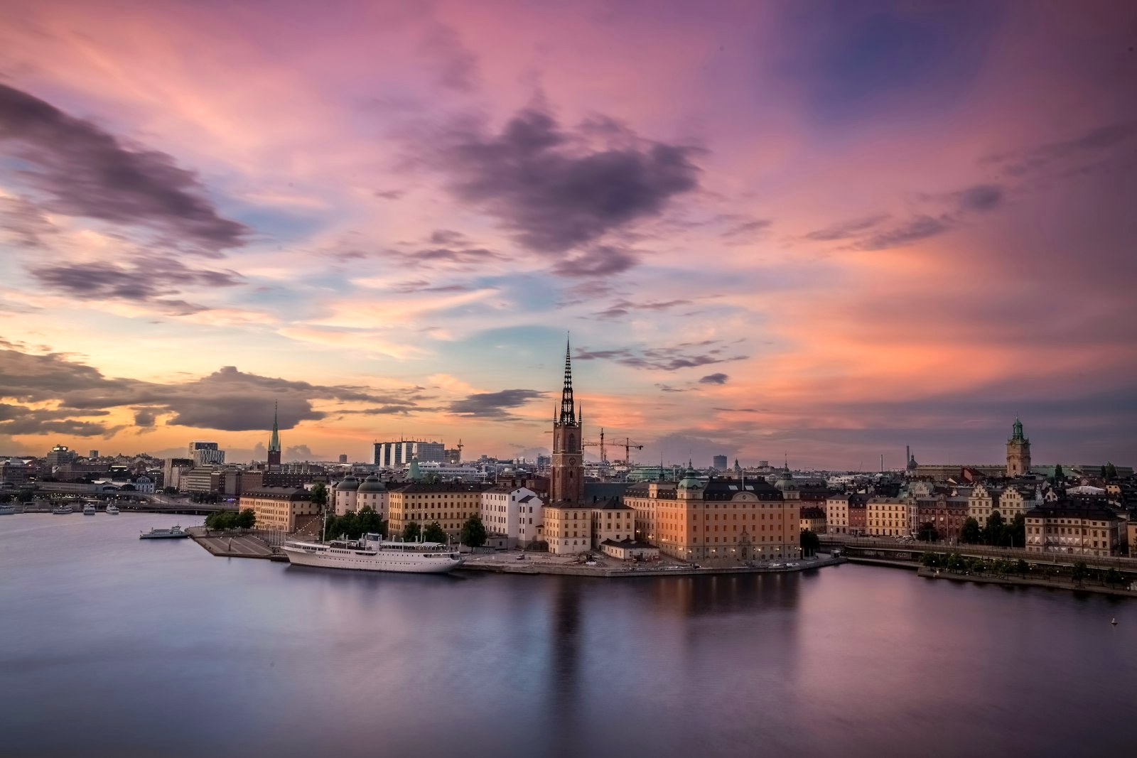 Stockholm's old town across the water at sunset, church spires over a calm harbour