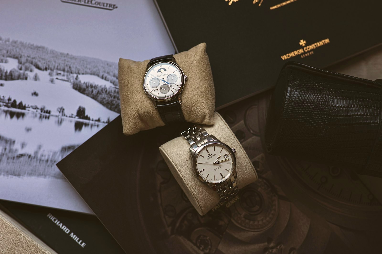 Two dress watches styled on an open magazine flat lay