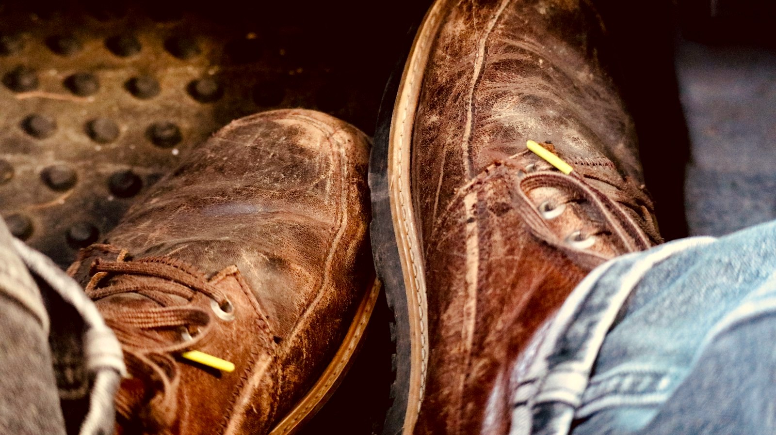 Heavily worn brown leather boots from above, scuffed and polished by years of wear
